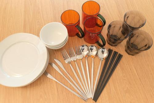 a table with plates and utensils and glasses and chopsticks at Cure Skytree in Tokyo