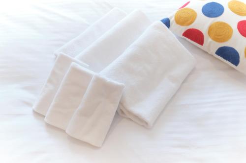 two white napkins sitting on top of a bed at Cure Skytree in Tokyo