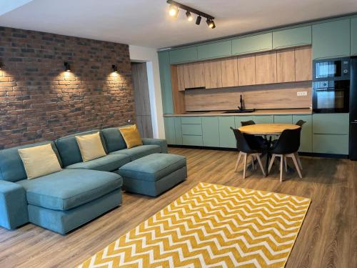 a living room with a couch and a table at Apartament Tei in Gura Humorului