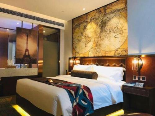 a bedroom with a large bed with a map on the wall at James Joyce Coffetel Chengdou Wuqing Wanda Plaza in Chengdu