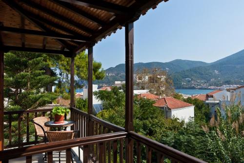 a patio with a view of the ocean and mountains at Sofia's Garden Studios in Skopelos Town
