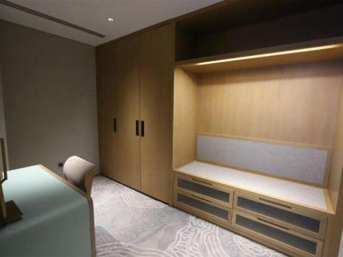 a room with a bed and a large cabinet at Empark Grand Hotel Fuzhou in Fuzhou