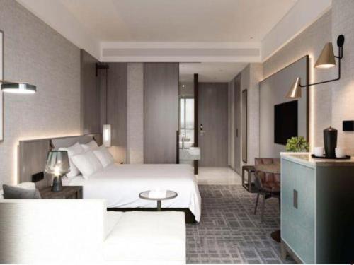 a hotel room with a bed and a living room at Empark Grand Hotel Fuzhou in Fuzhou