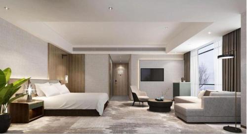 a hotel room with a bed and a couch at Empark Grand Hotel Fuzhou in Fuzhou