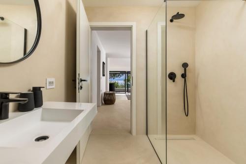 a bathroom with a sink and a shower at Villa Carla house with hot tub and beautiful garden in Ičići