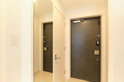 a bathroom with a black door in a room at Cure Skytree in Tokyo