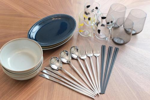 a table with forks and spoons and plates and glasses at Cure Skytree in Tokyo