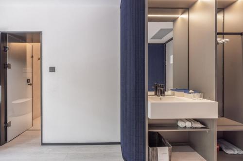 a bathroom with a sink and a mirror at Atour Light Hotel Beijing National Exhibition Center Yonghe Palace Guangximen Metro Station in Beijing