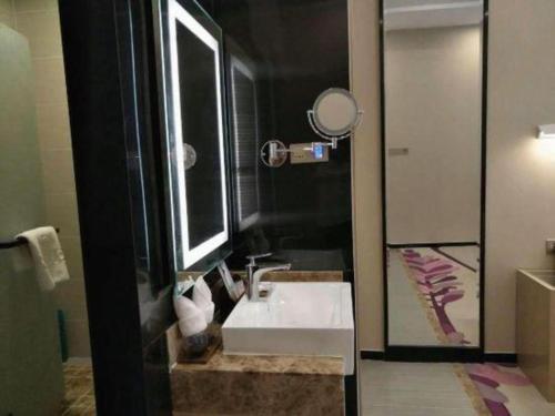 a bathroom with a sink and a mirror at Lavande Hotels Dalian Software Park University of Technology in Dalian