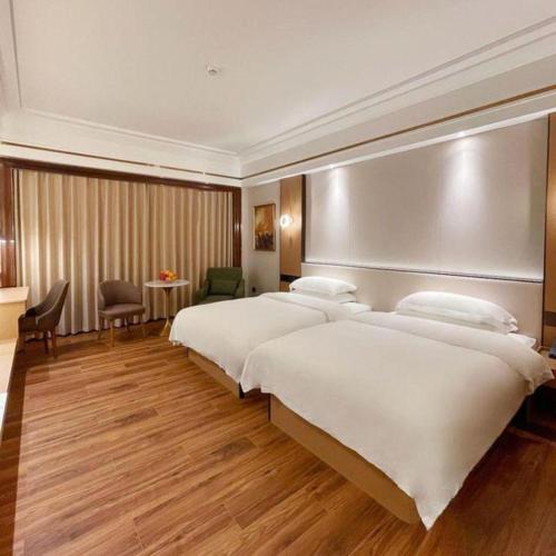 a hotel room with two beds and avisor at Chaozhou Hotel in Chaozhou