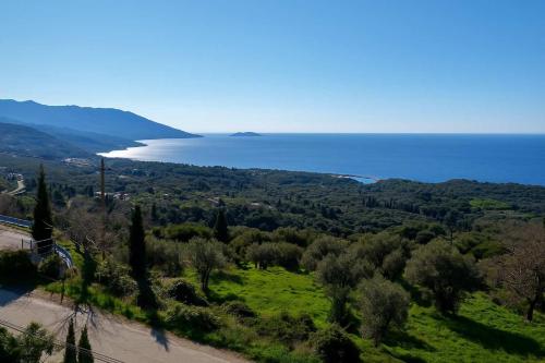 a view of the ocean from a hill with trees at Aegean Bliss - Marathos Retreat Samos in Kámpos