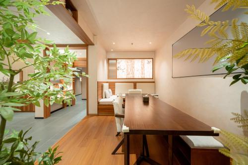 a dining room with a table and some plants at Xihe Hotel-Shanghai Lujiazui Lancun Road Subway Station Branch in Shanghai