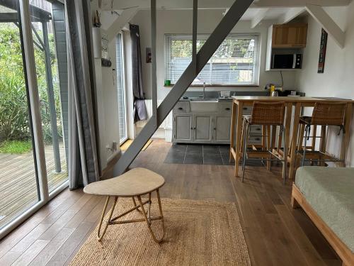 a small kitchen with a table and a chair in a room at Gîte Bambou in Saint-Lunaire