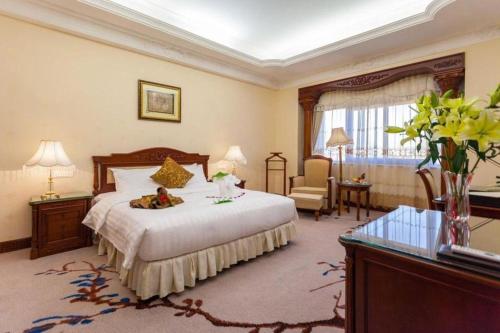 a hotel room with a bed with a teddy bear on it at Quanzhou Hotel in Quanzhou