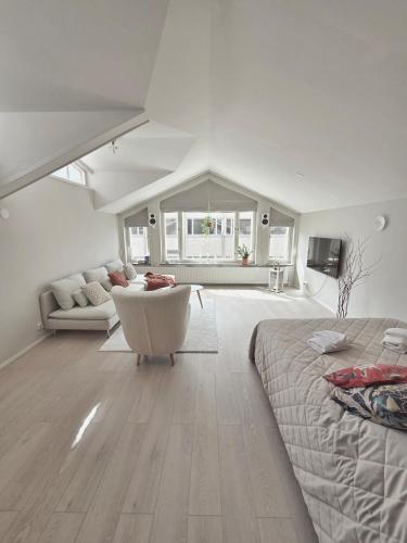 a living room with a bed and a couch at Kotoisa kattohuoneisto in Laitila
