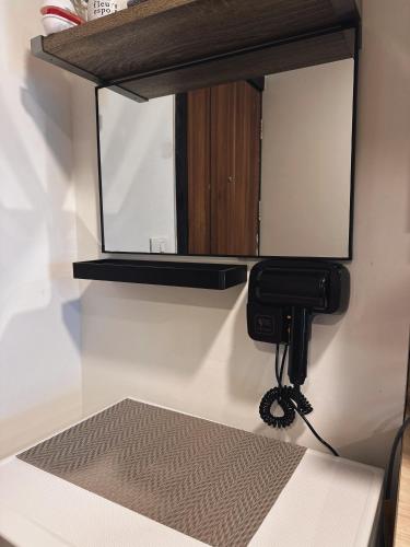 a mirror is hanging on a wall in a room at Condo with sunset view MAIKHAO in Ban Mai Salae
