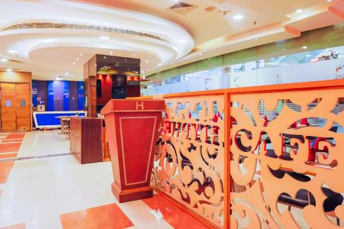 a dressing room with a red podium and a mirror at Hyphen Premier-Business Hotel in Meerut