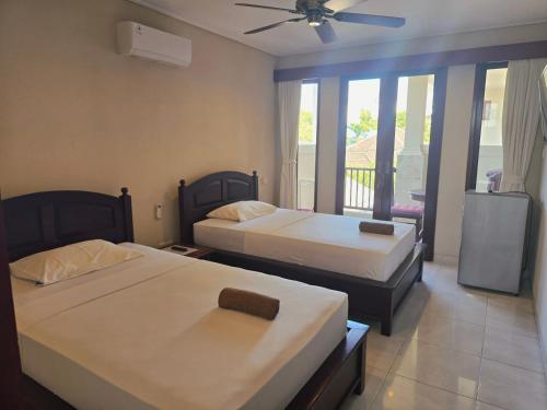 Postel nebo postele na pokoji v ubytování Keke Homestay Sanur