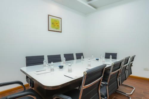 a conference room with a long table and chairs at Hyphen Premier-Business Hotel in Meerut