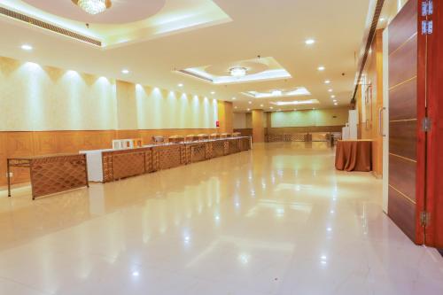 a large lobby with a waiting room and a long aisle at Hyphen Premier-Business Hotel in Meerut