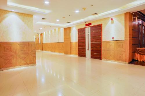 a hallway with wooden lockers in a building at Hyphen Premier-Business Hotel in Meerut