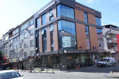 a large building on a city street with cars parked in front at garden hill hotel in Istanbul
