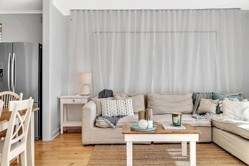 a living room with a couch and a table at Christies Grove - Seaside Bliss near McLaren Vale in Christies Beach