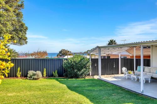 a house with a yard with a fence at Christies Grove - Seaside Bliss near McLaren Vale in Christies Beach