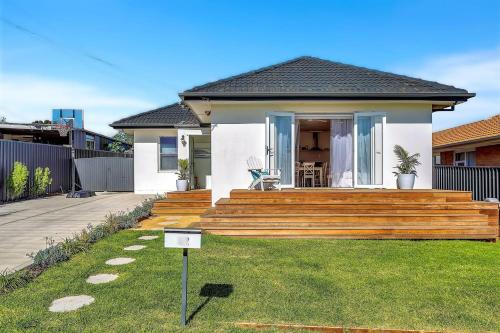 a home with a wooden deck in the yard at Christies Grove - Seaside Bliss near McLaren Vale in Christies Beach