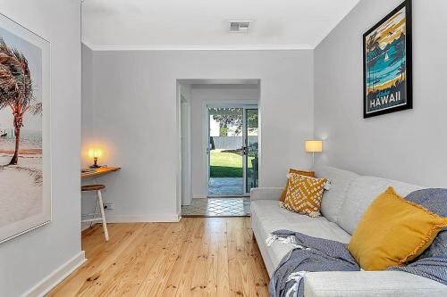 a living room with a couch and a table at Christies Grove - Seaside Bliss near McLaren Vale in Christies Beach
