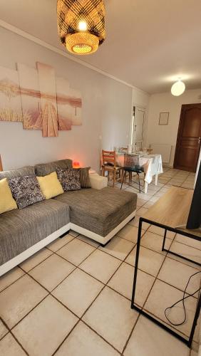 ein Wohnzimmer mit Sofa und Tisch in der Unterkunft Appartement 4 chambres - Grande Terrasse -Cergy Centre in Cergy