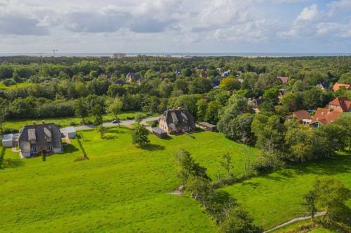an aerial view of a green field with houses at Haus Oase in Sankt Peter-Ording