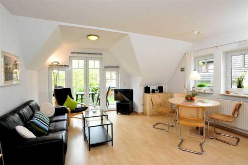 a living room with a couch and a table at Wohnung 5 Duenengras ID 115 in Sankt Peter-Ording