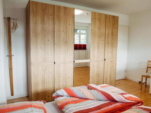 a bedroom with a large wooden closet in a room at Ferienwohnung Wennetal in Schmallenberg