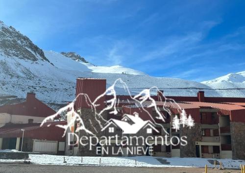 a building with a sign on it in the snow at Hermoso departamento frente a las montañas in Los Penitentes