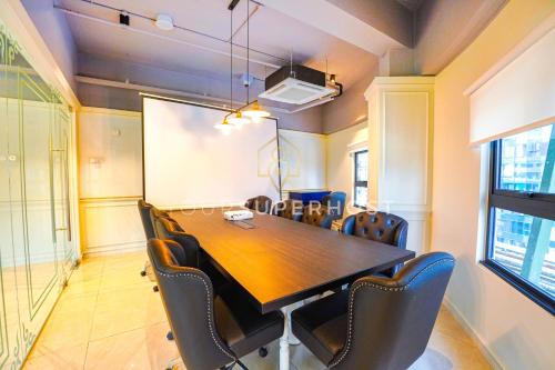 a conference room with a wooden table and chairs at Paxtonz by YourSuperhost in Kuala Lumpur