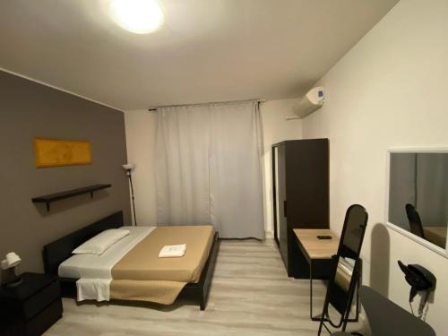 a bedroom with a bed and a desk in a room at Guest House Pirelli Milano in Milan