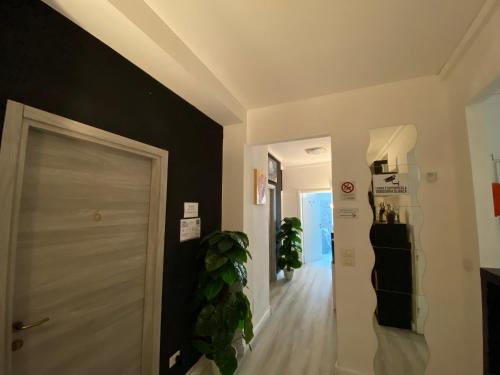 a hallway with a white door and a black wall at Guest House Pirelli Milano in Milan
