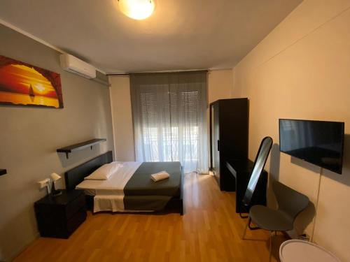 a bedroom with a bed and a television in it at Guest House Pirelli Milano in Milan
