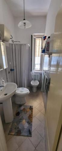 a bathroom with a toilet and a sink at Casamare in Roseto degli Abruzzi