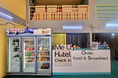 a refrigerator in a store with a sign on it at Me U Hostel in Chiang Mai