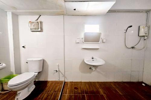 a bathroom with a toilet and a sink at Me U Hostel in Chiang Mai