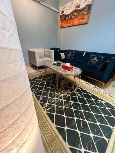 a living room with a couch and a table at Classy & Private Flat 106 in Al Khobar