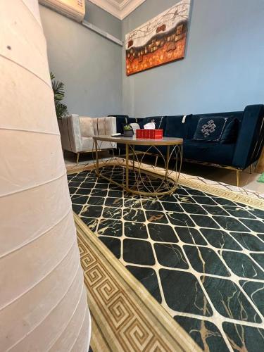 a living room with a couch and a table at Classy & Private Flat 106 in Al Khobar