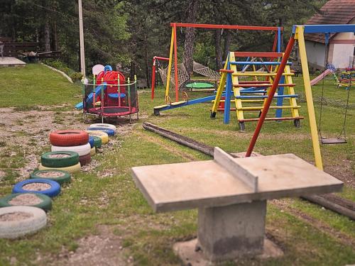 a playground with colorful play equipment in a yard at Pastirica in Divčibare