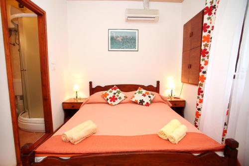 a bedroom with a bed with towels on it at Rooms & Studio Stipcic in Trogir
