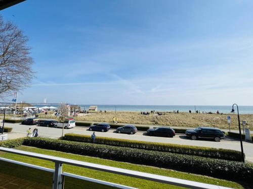 a parking lot with cars parked next to the beach at Bellevue Nr. 25 in Scharbeutz