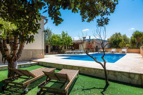 two chairs sitting next to a swimming pool at Son Fransi Alaro in Alaró