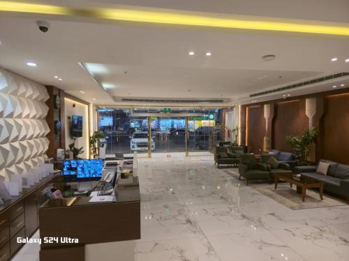 a lobby of a hotel with couches and chairs at Namar Home Serviced Apartment - Tuwaiq  in Riyadh
