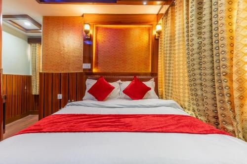 a bedroom with a large bed with red pillows at OYO 830 Hotel Amrit Kunja in Kathmandu
